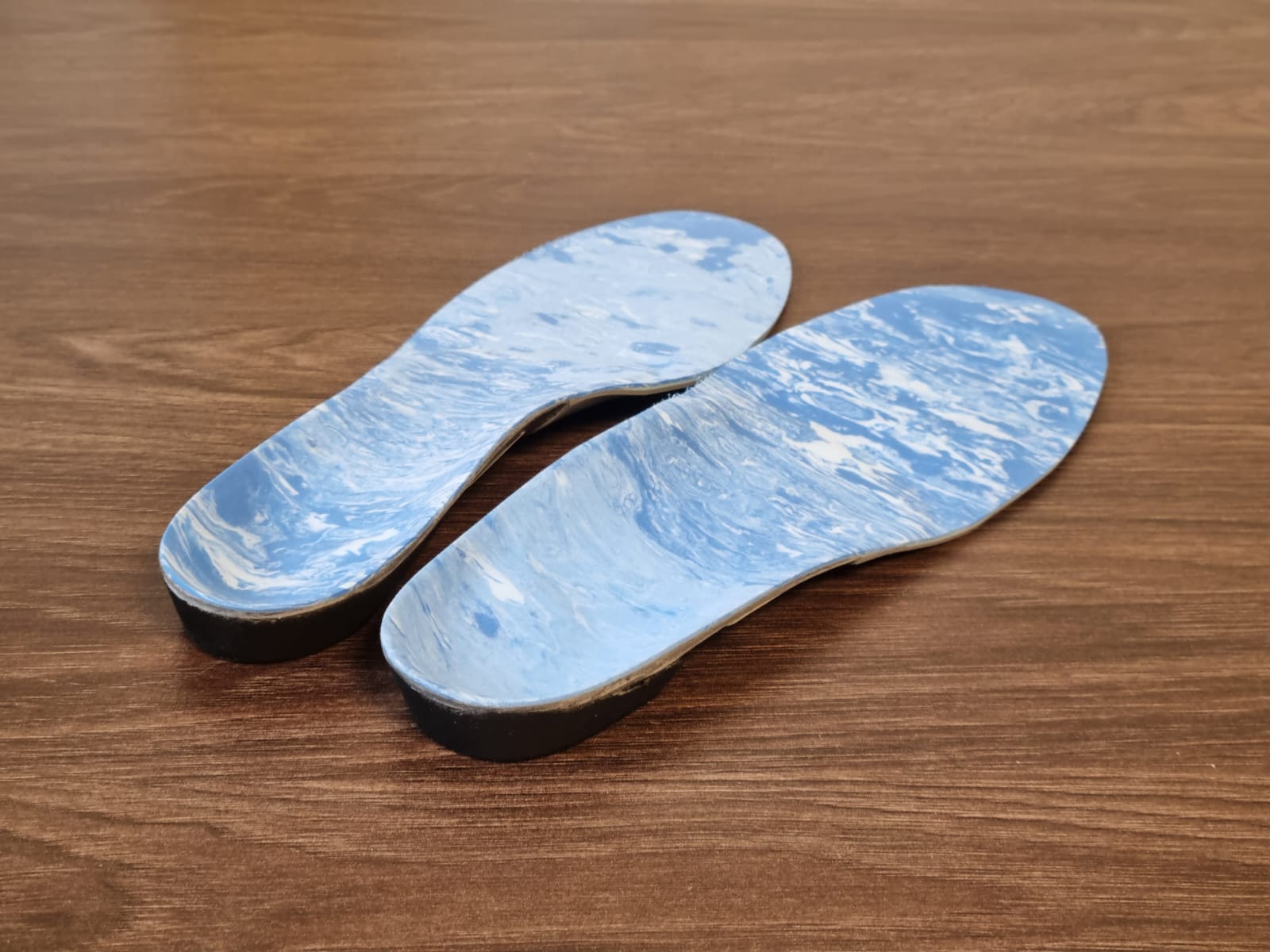 Custom orthotic insoles being fitted into a shoe